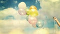 Girl hand holding multi colored balloons Royalty Free Stock Photo