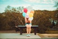 Girl hand holding multicolor balloons