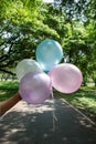 Girl hand holding multicolored balloons done with a retro vintage concept of happy birthday in summer and wedding Royalty Free Stock Photo