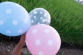 Girl hand holding multicolored balloons done with a retro vintage concept of happy birthday in summer and wedding honeymoon Royalty Free Stock Photo