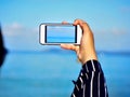 Girl hand taking photo at beach Royalty Free Stock Photo