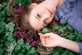A beautiful girl with hand is lying on the grass in flowers Royalty Free Stock Photo