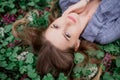 A girl with hand is lying on the grass in flowers Royalty Free Stock Photo