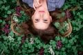 A girl with hand is lying on the grass in flowers Royalty Free Stock Photo