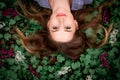 A girl with hand is lying on the grass in flowers Royalty Free Stock Photo