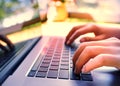 Girl hand typing laptop keyboard in concept coffee shop Wireless data entry and technology Royalty Free Stock Photo