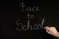 Girl hand write word Back To School on blackboard with white chalk Royalty Free Stock Photo