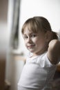 Girl With Hands Behind Head Smiling At Home