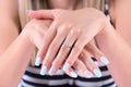 Elegance and Bliss: Blue Manicure and Diamond Rings