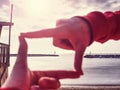 Girl hands capture piuer with lighthouse at sea