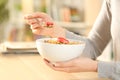 Girl hands with cereal bowl eating healthy breakfast at home Royalty Free Stock Photo