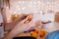 Girl with hands cleans tangerine at home