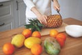 Girl hands cutting fruits on cutting board, close up shot. Healthy eating concept