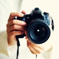 Girl hands holding photo camera, white background, copy space. Travel and shoot concept. Square crop Royalty Free Stock Photo