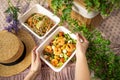Girl hands are holding plastic container of shrimp salad. food delivery concept to office, home or picnic. unrecognizable people Royalty Free Stock Photo