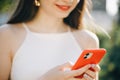 Girl Hands holding smartphone. Woman Using Smartphone in Beautiful Green Park. Technology outdoors Royalty Free Stock Photo