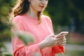 Girl Hands holding smartphone. Woman Using Smartphone in Beautiful Green Park. Technology outdoors Royalty Free Stock Photo