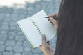 Girl hands with pen writing on notebook in park Royalty Free Stock Photo