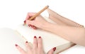 Girl hands with pencil on personal diary