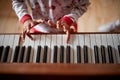 Girl hands playing on piano.winter holidays and family concept Royalty Free Stock Photo