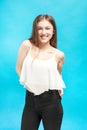 Girl with hands in pockets smiles broadly Royalty Free Stock Photo