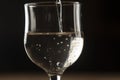 pouring red wine into a glass from a clay bottle on a black background Royalty Free Stock Photo