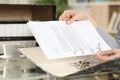 Girl hands putting documents on a ring binder