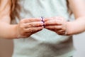 Girl with hands in soap holds an abstract model of coronavirus