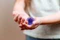 Girl with hands in soap holds an abstract model of coronavirus.