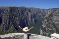 Girl with hands up on the viewpoint Vikos gorge Royalty Free Stock Photo