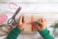 Girl hands wrapping gift for Christmas presents and New Year.