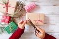 Girl hands wrapping gift for Christmas presents and New Year.