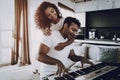 Girl Is Hanging A Boyfriend Playing Synthesizer. Royalty Free Stock Photo