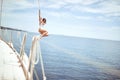 Girl hanging out, having fun and enjoying summer days jumping from sailing boat in sea Royalty Free Stock Photo