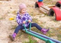 girl happily swinging on a swing in the yard