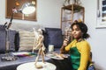 Girl happily at a table, surrounded by an array of creative materials for painting to inspire their next great idea