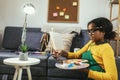 Girl happily at a table, surrounded by an array of creative materials for painting to inspire their next great idea