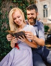 Girl with happy face holds old book. Romantic date and love concept. Couple spend time together Royalty Free Stock Photo