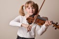 Girl happy looking straight ahead playing violin Royalty Free Stock Photo