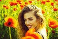 Pretty woman or happy girl in field of poppy seed Royalty Free Stock Photo