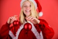 Girl happy wear santa costume celebrate christmas hold ball decor. Christmas preparation concept. Lets decorate