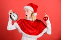 Girl happy wear santa costume celebrate christmas hold ball decor red background. Christmas preparation concept Royalty Free Stock Photo