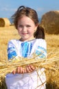 Girl on harvest field with straw bales Royalty Free Stock Photo