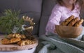 The girl has a delicious chocolate biscuit breakfast. A child is sitting on a Dwan and branches of a Christmas tree. Home comfort Royalty Free Stock Photo