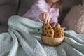 The girl has a delicious chocolate biscuit breakfast. The child is sitting on Dwan. Home comfort and natural light in the photo. Royalty Free Stock Photo