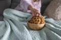 The girl has a delicious chocolate biscuit breakfast. The child is sitting on Dwan. Home comfort and natural light in the photo. Royalty Free Stock Photo