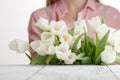 Girl has just bestowed a bouquet of white tulips