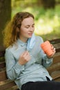 A girl has removed her surgical mask to take a sip from a mug. Royalty Free Stock Photo