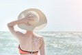 Girl in a hat against sea. On the back is painted sun Royalty Free Stock Photo