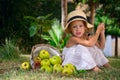 Girl in a hat and a basket of apples Royalty Free Stock Photo